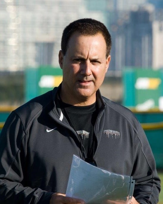 Tony Abbatine on the field in a Frozen Ropes jacket, holding a practice plan