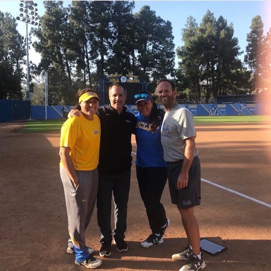 Tony Abbatine on a softball field with players and staff